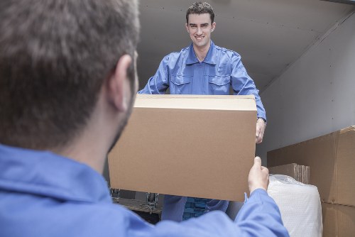 Man and van removals team loading furniture in Woodford