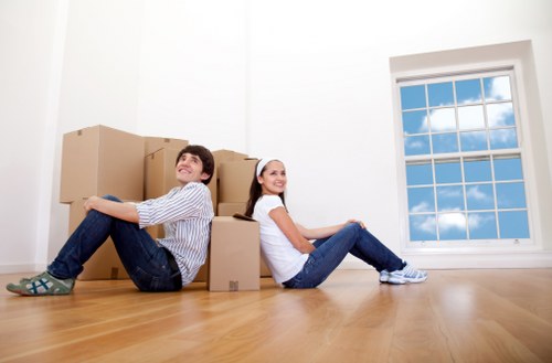 Local movers handling packed household items in Woodford
