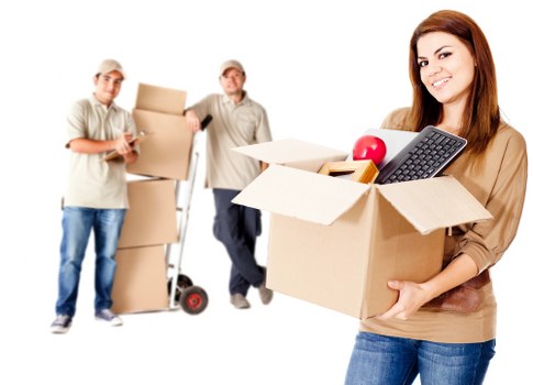 Furniture and boxes being loaded into a removal van in Woodford