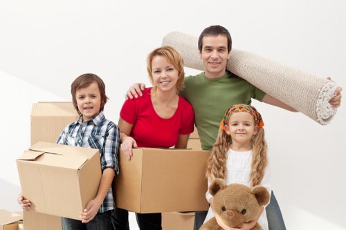 Trained movers in Woodford using PPE and safe lifting techniques
