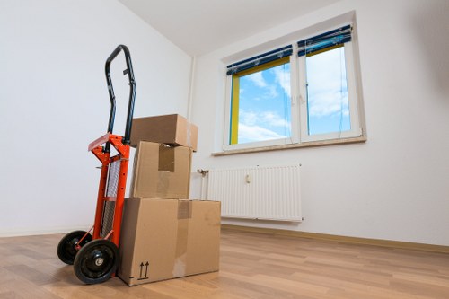 Office movers handling equipment and desks carefully